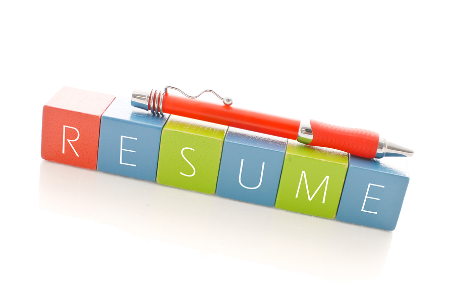 blocks spelling resume with and orange pen on top